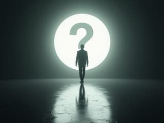 Person walking towards a bright light with a question mark, studio setup