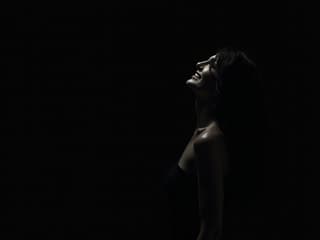 Silhouette of a woman with a mysterious smile, studio lighting, dark background