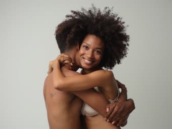 Studio portrait of a person embracing themselves, symbolizing self-acceptance