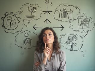 Woman at career crossroads, multiple career path symbols, thoughtful expression, studio backdrop